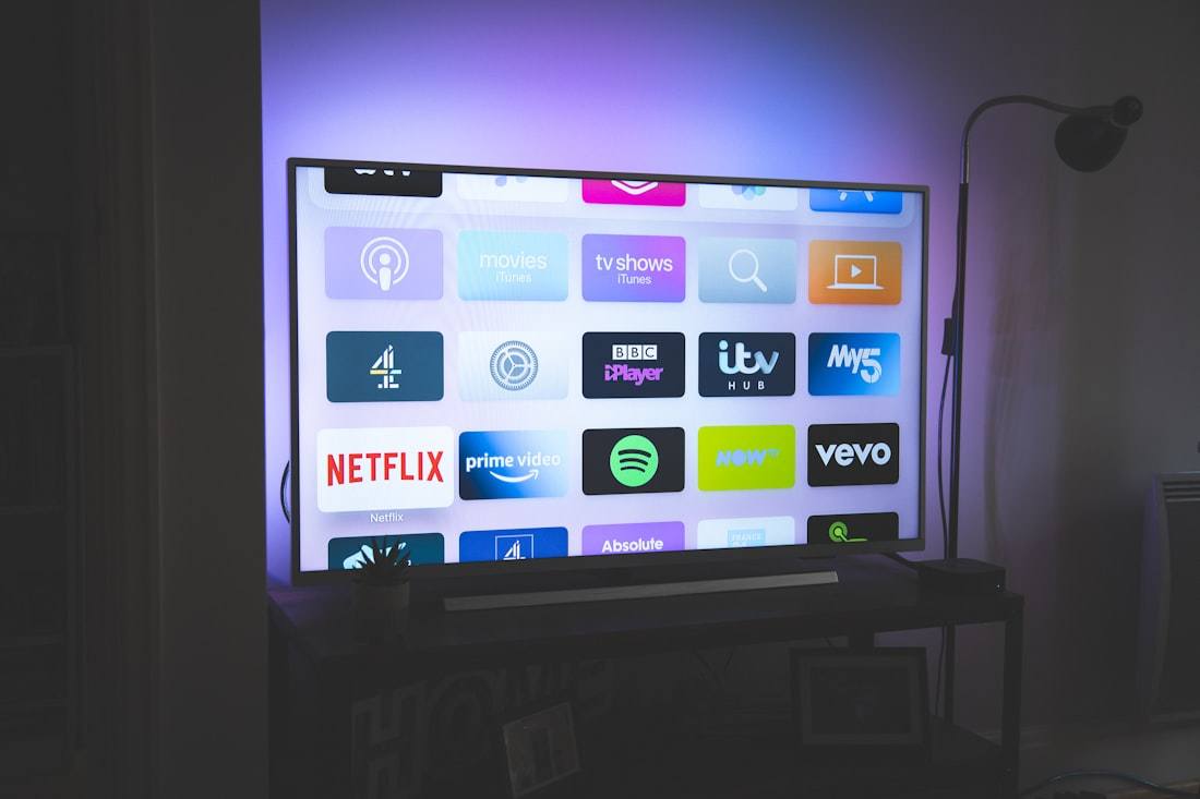 A wall of TV app tiles on the living-room screen